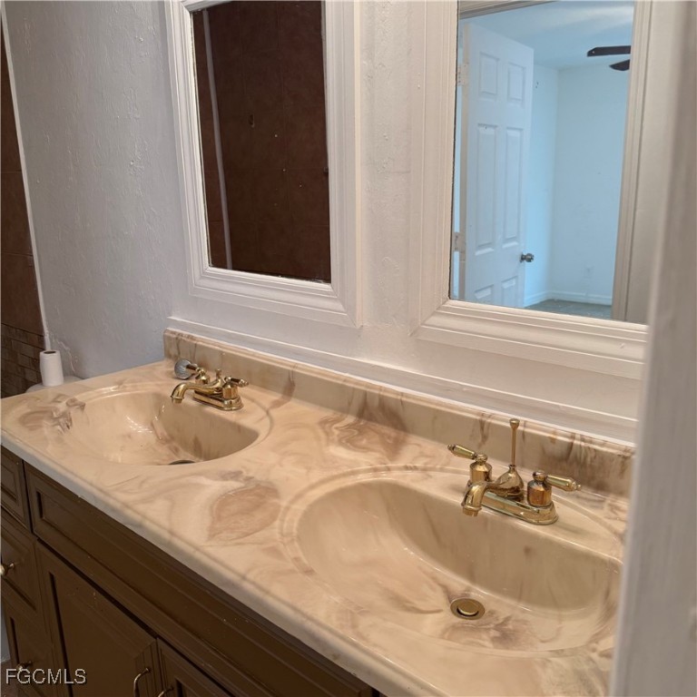 2172 Simon Court Fort Myers, FL 33916 - Photo 15 of 15 a bathroom with a sink and a mirror