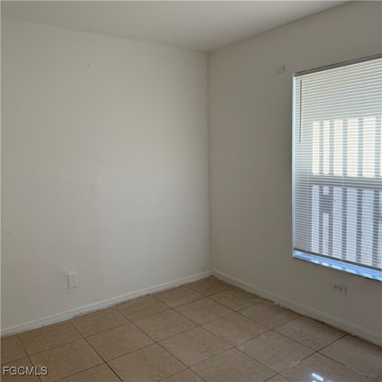 2172 Simon Court Fort Myers, FL 33916 - Photo 5 of 15 an empty room with a window