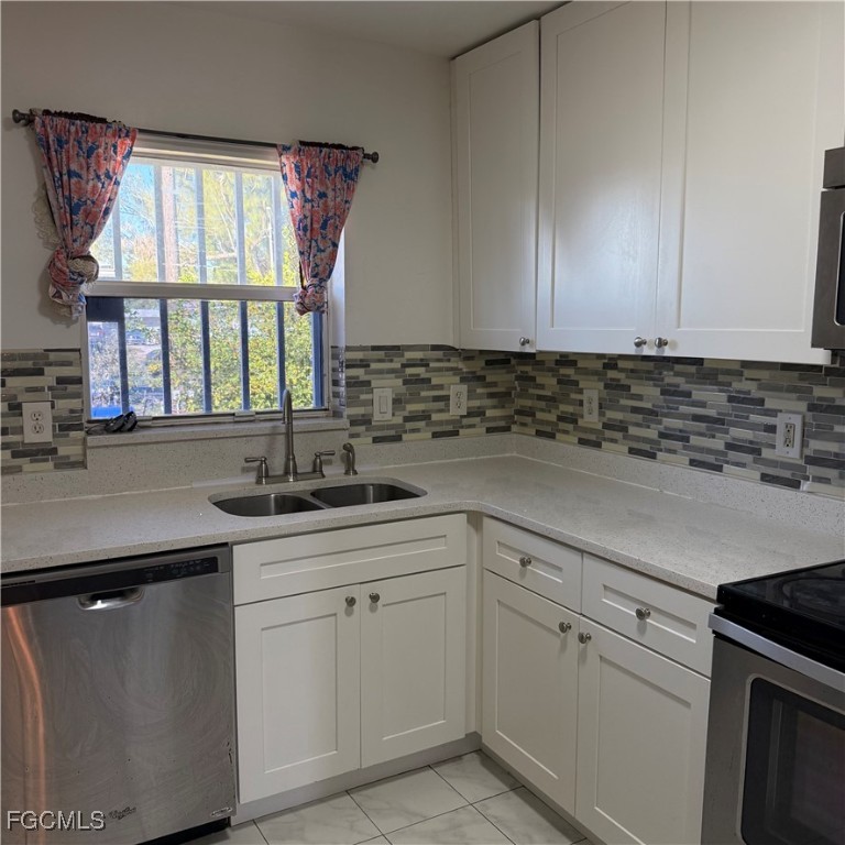 2172 Simon Court Fort Myers, FL 33916 - Photo 10 of 15 a kitchen with a sink window and cabinets