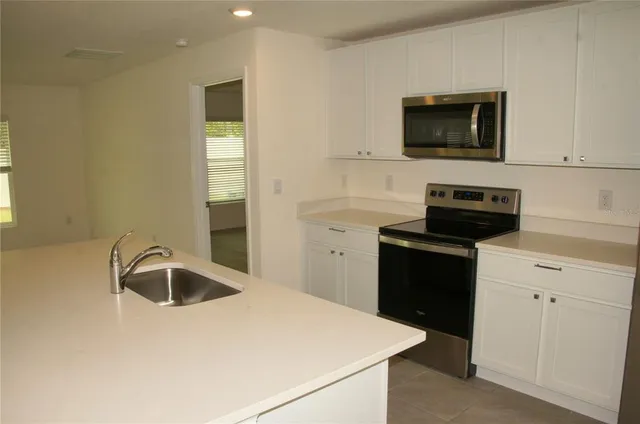 a kitchen with a sink and a microwave