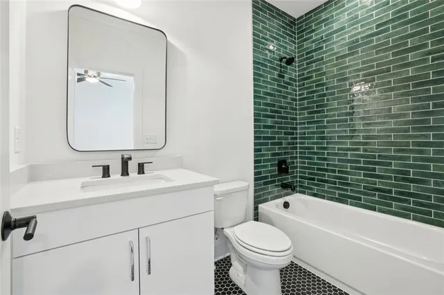 a bathroom with a double vanity sink toilet mirror and shower