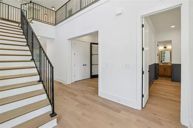 a view of a hallway with wooden floor and staircase
