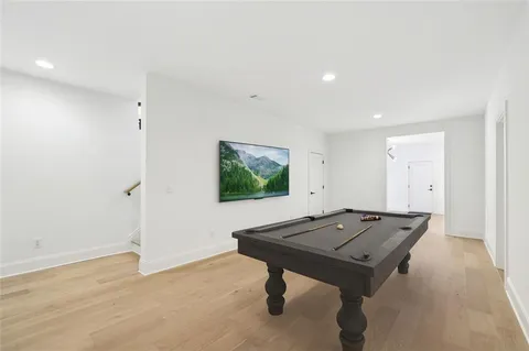 a view of empty room with wooden floor and window