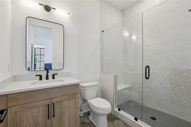 a bathroom with a toilet sink and shower