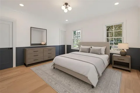 a bedroom with a large bed and a chandelier