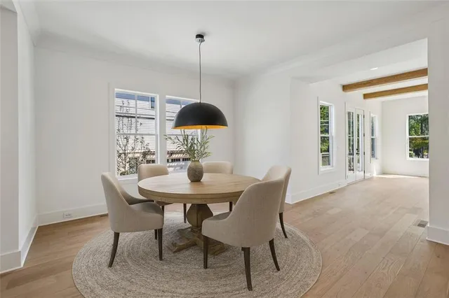 a view of a dining room with furniture window and wooden floor