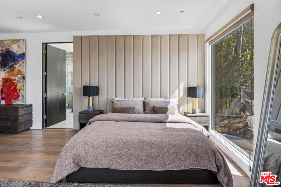 6696 Lakeridge Road Los Angeles, CA 90068 - Photo 12 of 19 a bedroom with a bed and a large window
