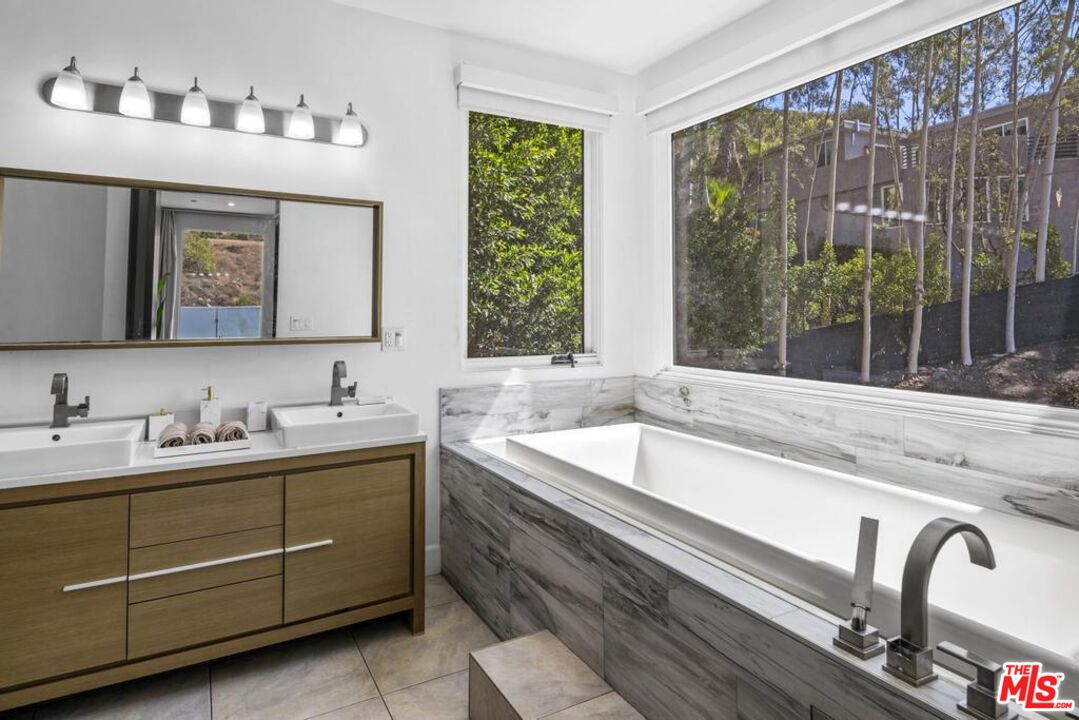 6696 Lakeridge Road Los Angeles, CA 90068 - Photo 13 of 19 a bathroom with a granite countertop sink and a bathtub