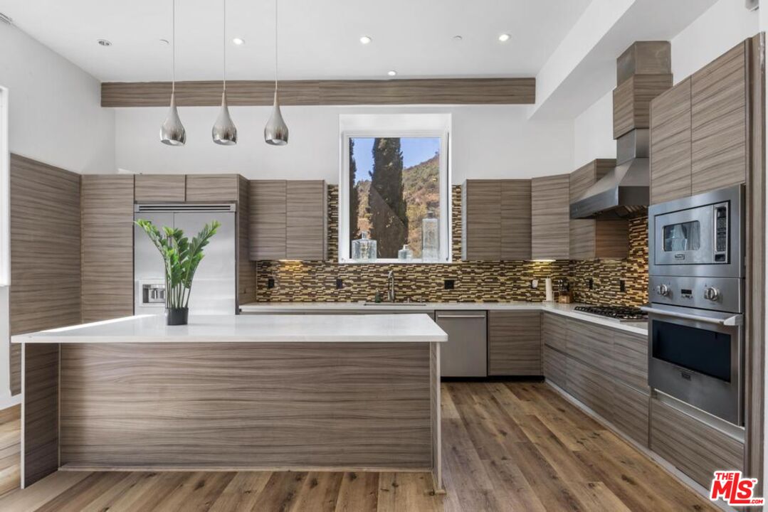 6696 Lakeridge Road Los Angeles, CA 90068 - Photo 4 of 19 a kitchen with a sink and cabinets