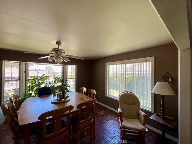 a dining room with furniture window and wooden floor