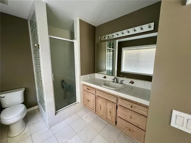 a view of a refrigerator in kitchen and a wooden floor