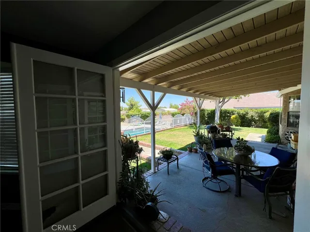 a view of house with backyard porch and sitting area