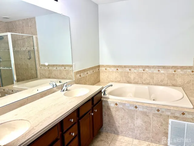 a bathroom with a bathtub and shower