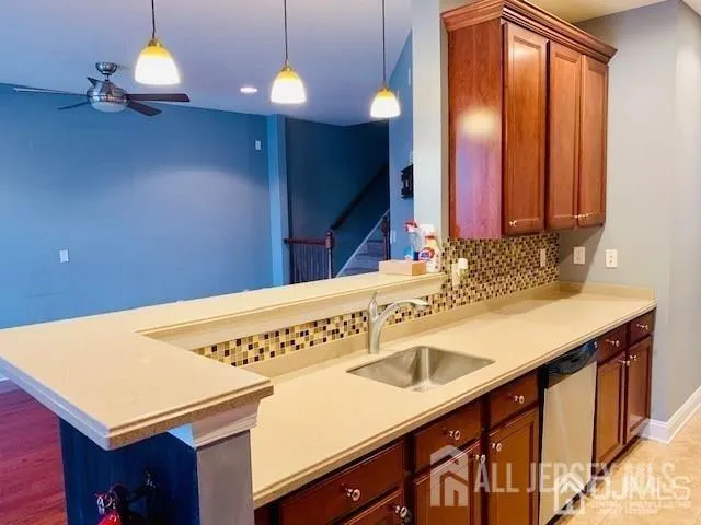a view of a kitchen with a sink and wooden floor