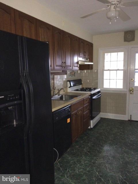 428 Overbrook Road Baltimore, MD 21212 - Photo 6 of 13 a kitchen with a sink stainless steel appliances and cabinets