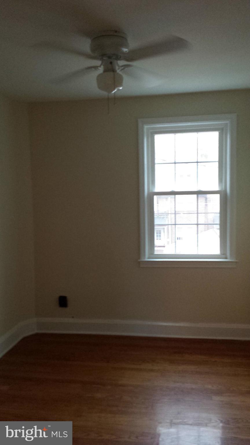 428 Overbrook Road Baltimore, MD 21212 - Photo 9 of 13 a view of an empty room with wooden floor and a window