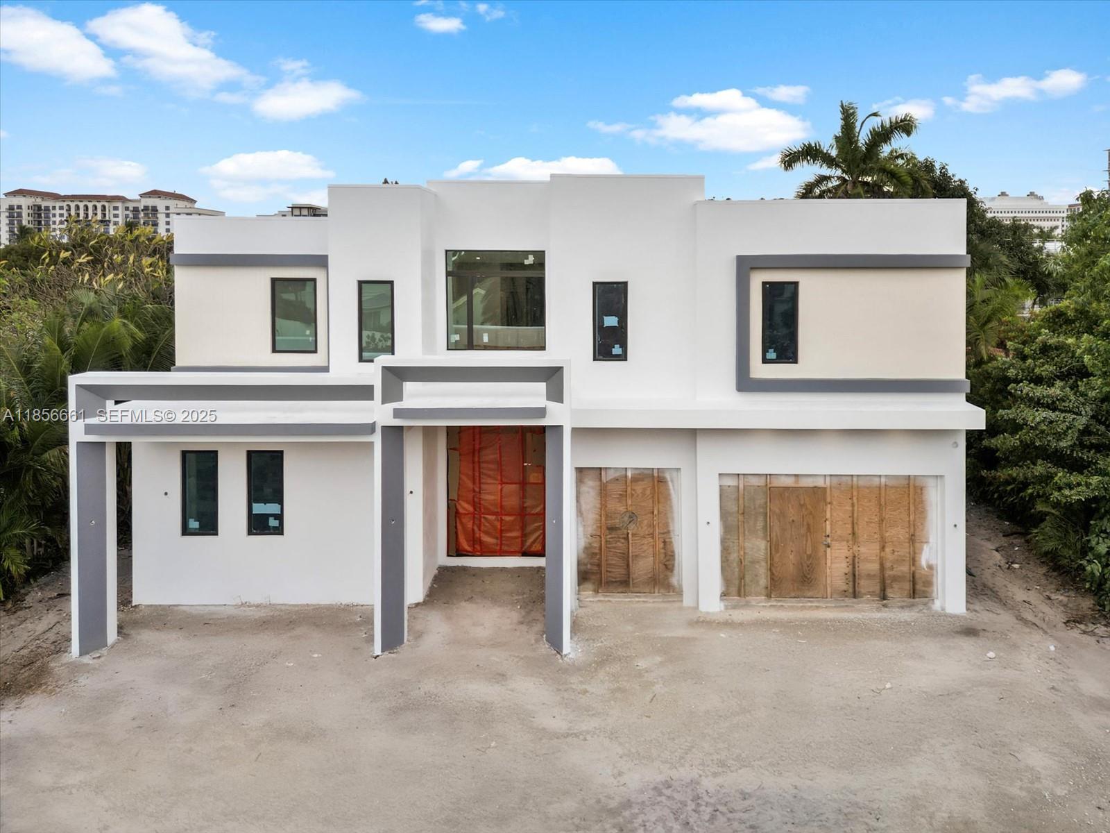 a view of a white house with large windows