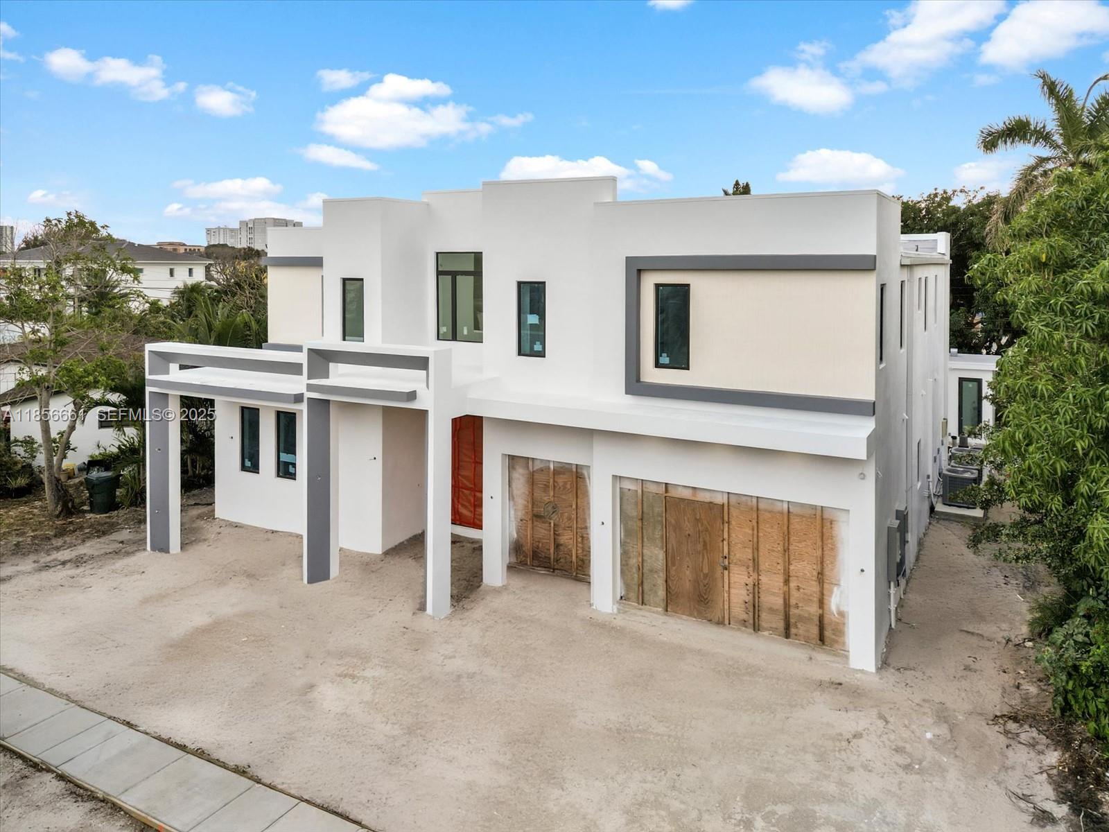 274 Northeast 3rd Court Boca Raton, FL 33432 - Photo 2 of 9 a view of a house with a yard and garage