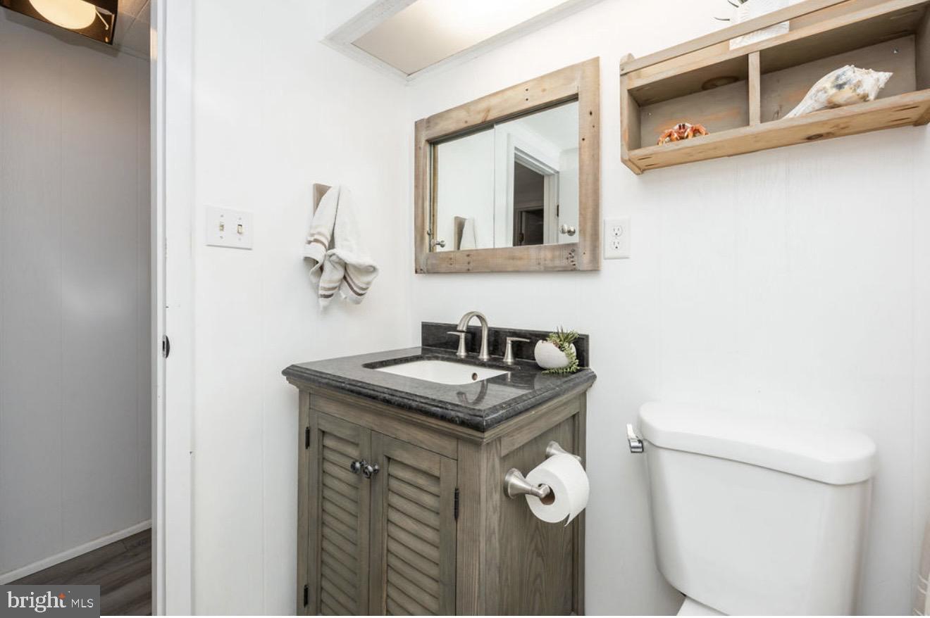 5 Falcon Bridge Road Ocean Pines, MD 21811 - Photo 23 of 59 a bathroom with a granite countertop sink and a mirror