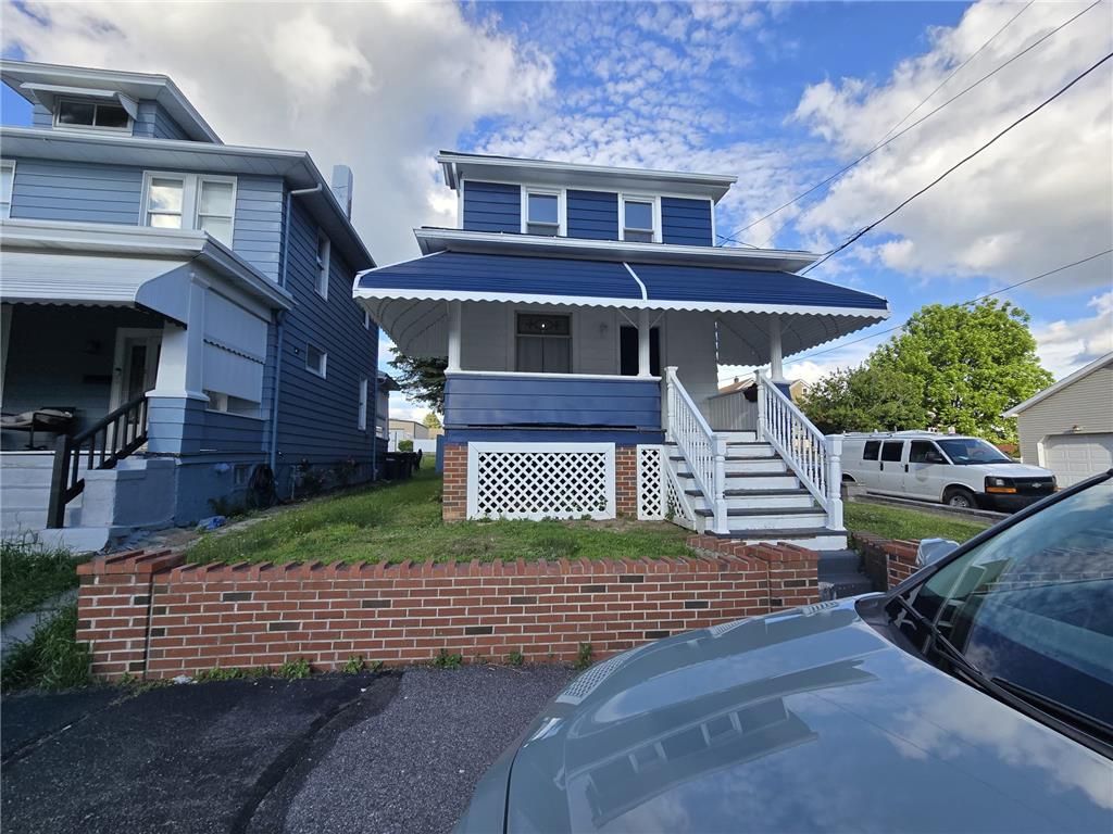 883 North Locust Street Hazleton, PA 18201 - Photo 9 of 83 A charming blue residence with a welcoming covered front porch and classic white railings.
