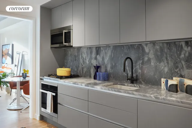 a kitchen with a sink and a stove top oven