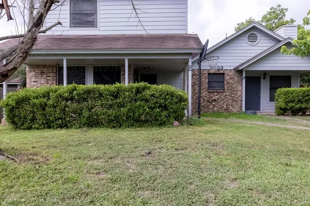 a view of a brick house with a yard