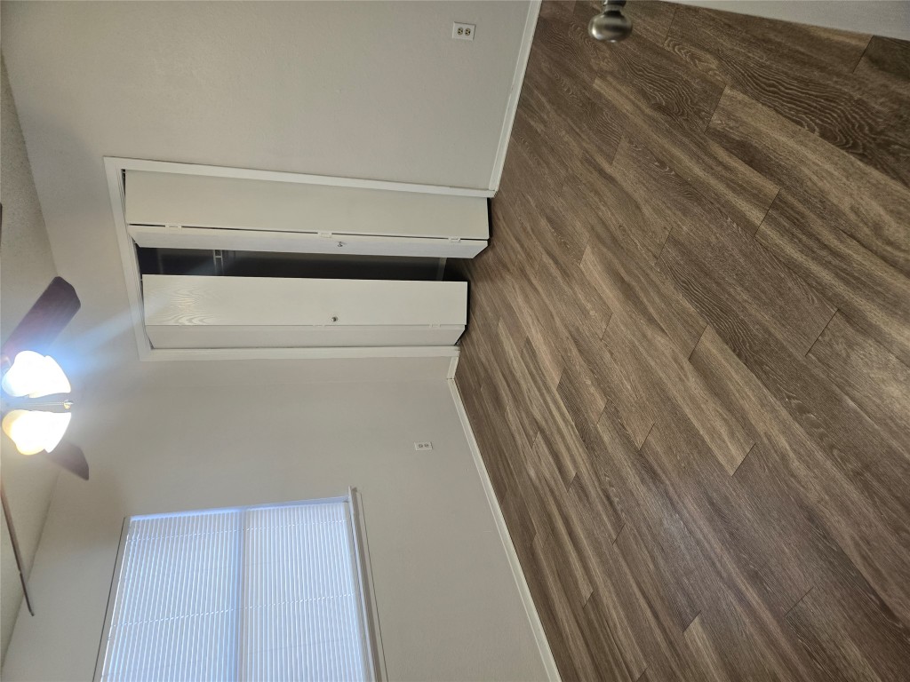 2903 West Slaughter Lane, Unit B Austin, TX 78748 - Photo 13 of 20 a view of an empty room with wooden floor and a chandelier fan