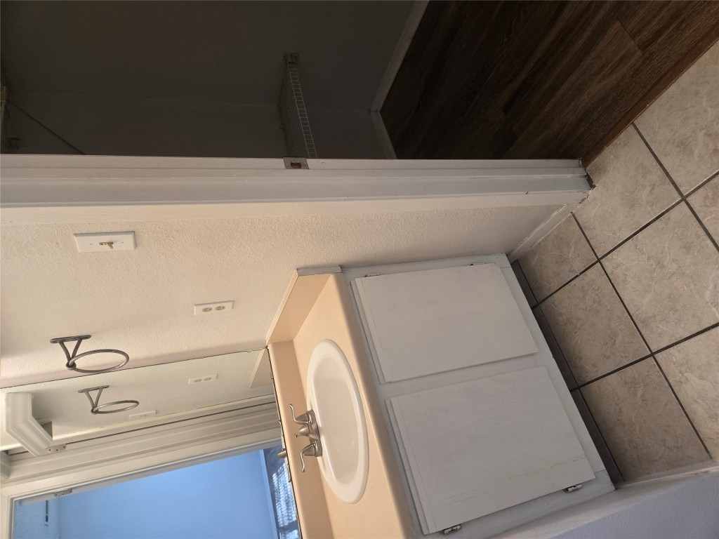 2903 West Slaughter Lane, Unit B Austin, TX 78748 - Photo 16 of 20 a bathroom with a sink and a mirror