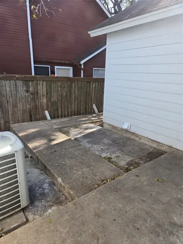 a view of a backyard with wooden fence