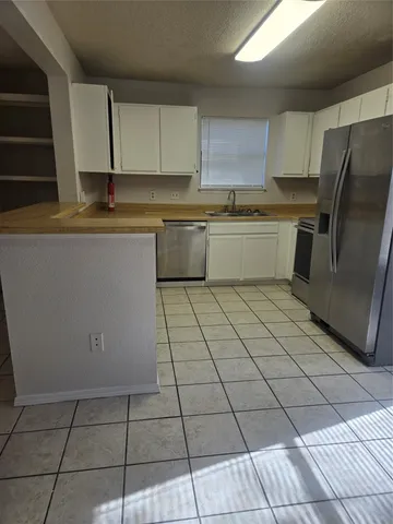 a kitchen with a sink a counter top space and cabinets