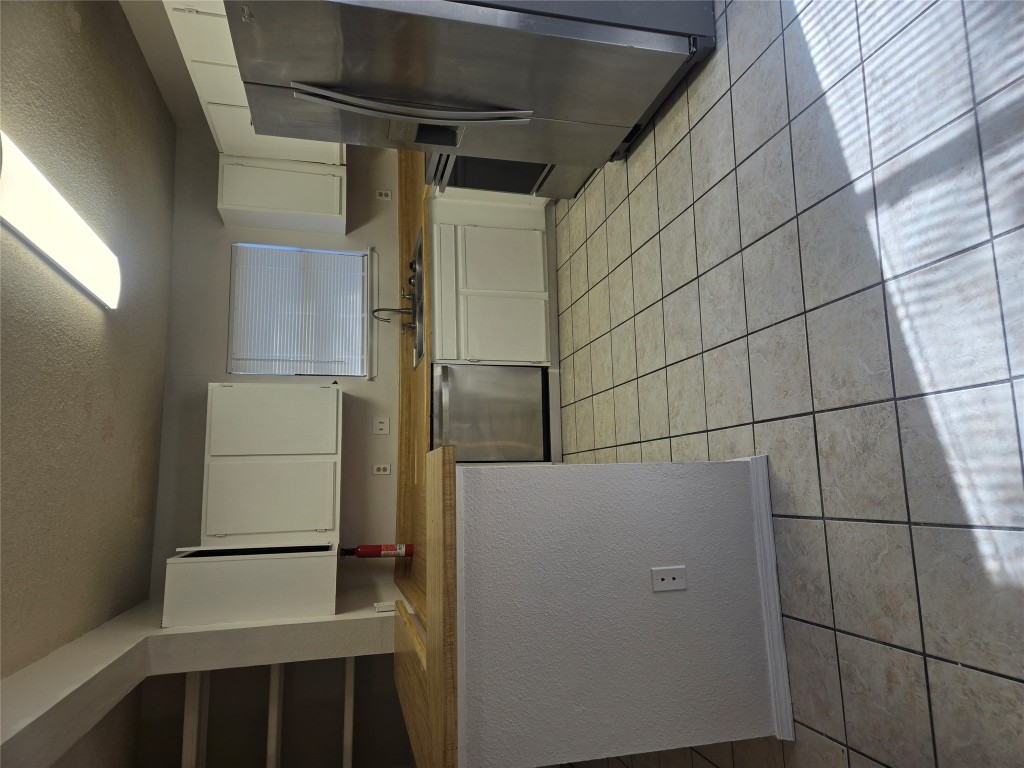 2903 West Slaughter Lane, Unit B Austin, TX 78748 - Photo 3 of 20 a kitchen with a sink a counter top space and cabinets