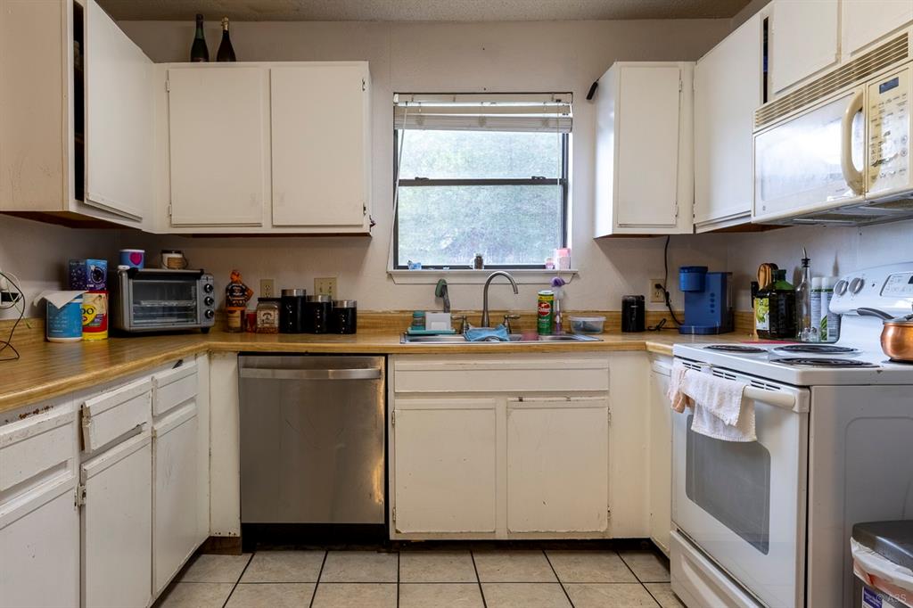 2903 West Slaughter Lane, Unit B Austin, TX 78748 - Photo 5 of 9 a kitchen with cabinets appliances a sink and a window
