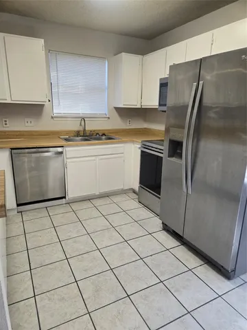 a kitchen with a stove a sink and a refrigerator