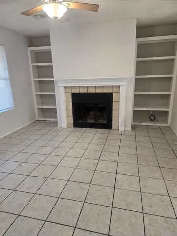 a view of an empty room with a fireplace