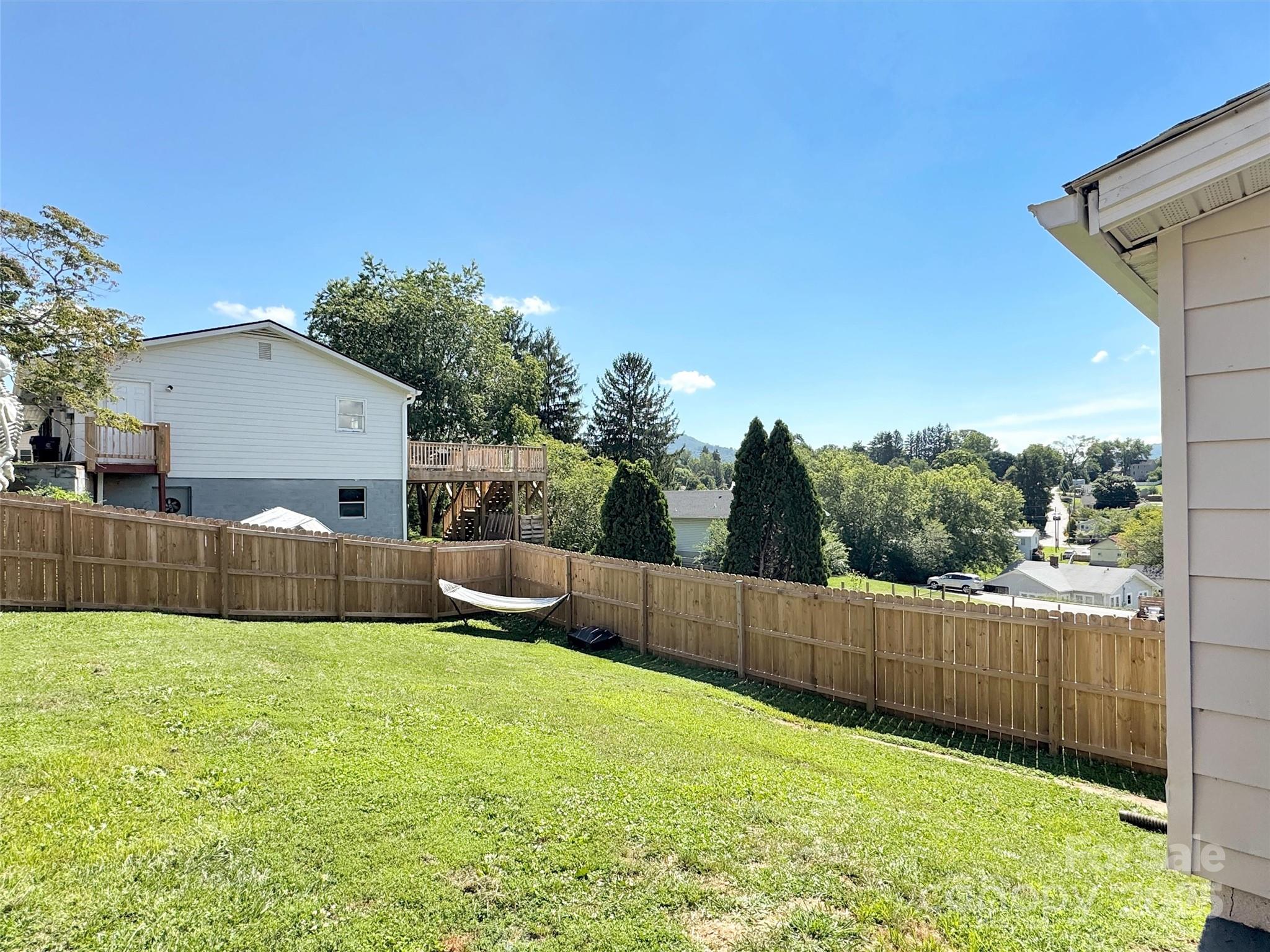 82 Elizabeth Street Canton, NC 28716 - Photo 15 of 17 a view of a backyard with a tub and wooden fence