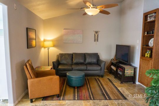 718 La Paloma Street Ridgecrest, CA 93555 - Photo 30 of 50 a living room with furniture and a flat screen tv