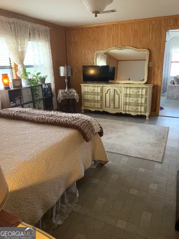 a bedroom with a bed and window