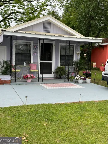 a view of a house with sitting area and garden