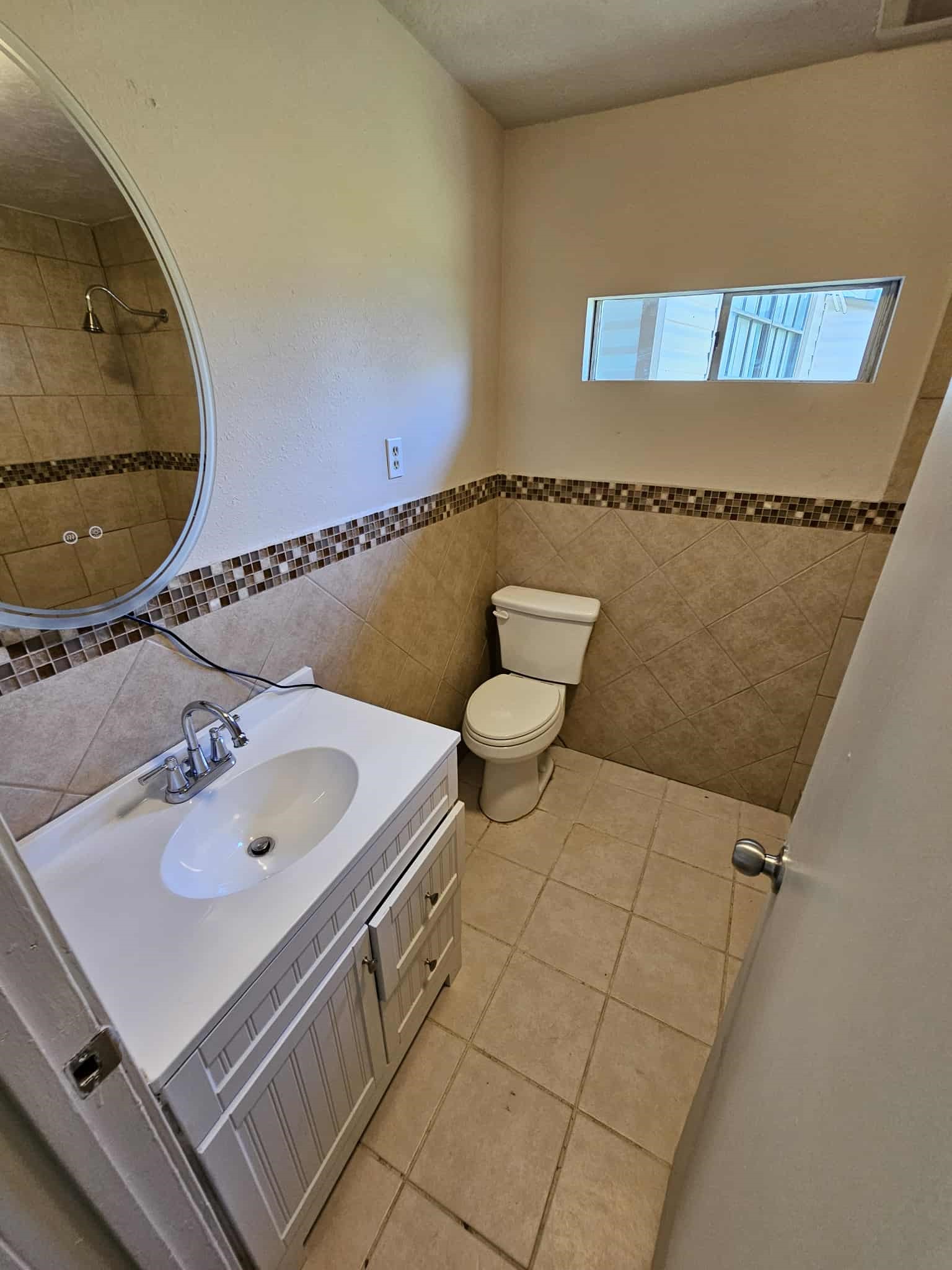 4115 Bering Street, Unit B Houston, TX 77003 - Photo 6 of 8 a bathroom with a sink toilet and a mirror