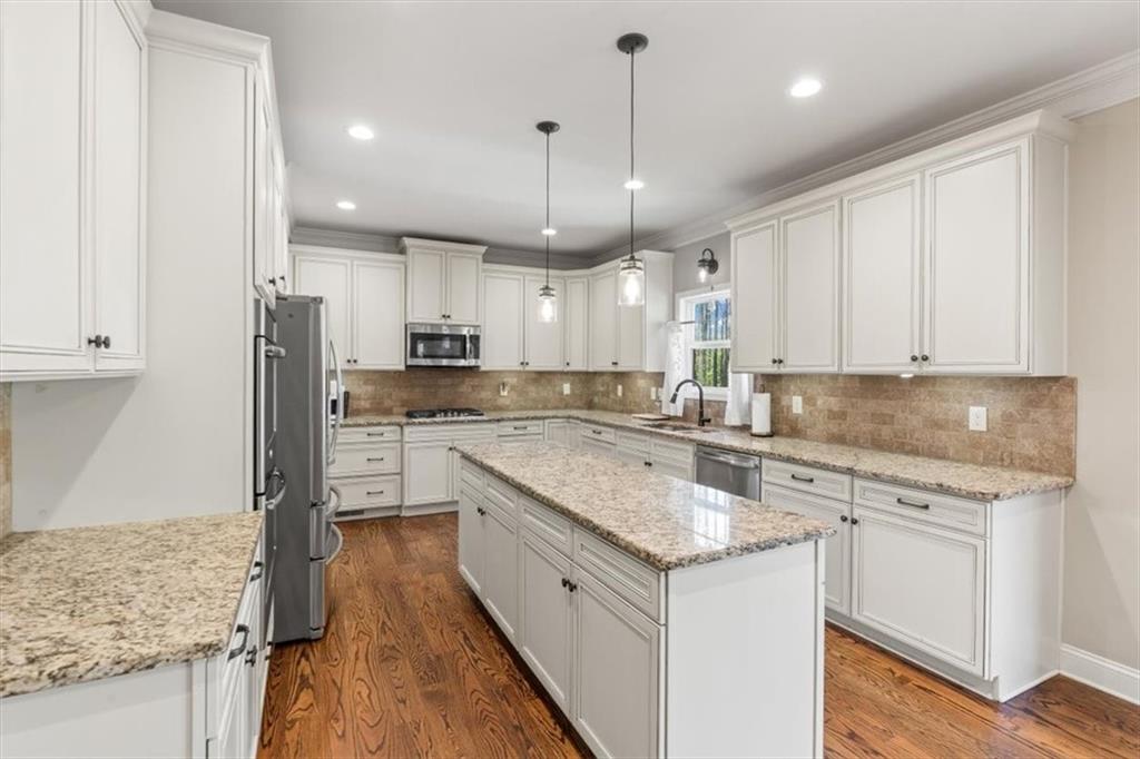 802 Double Branches Lane Dallas, GA 30132 - Photo 18 of 80 a large kitchen with granite countertop a sink a counter space stainless steel appliances and cabinets