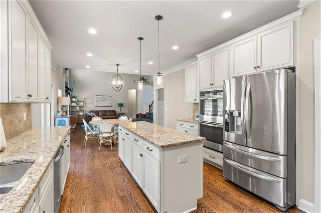802 Double Branches Lane Dallas, GA 30132 - Photo 20 of 80 a kitchen with stainless steel appliances kitchen island granite countertop a refrigerator a oven a sink and white cabinets with wooden floor