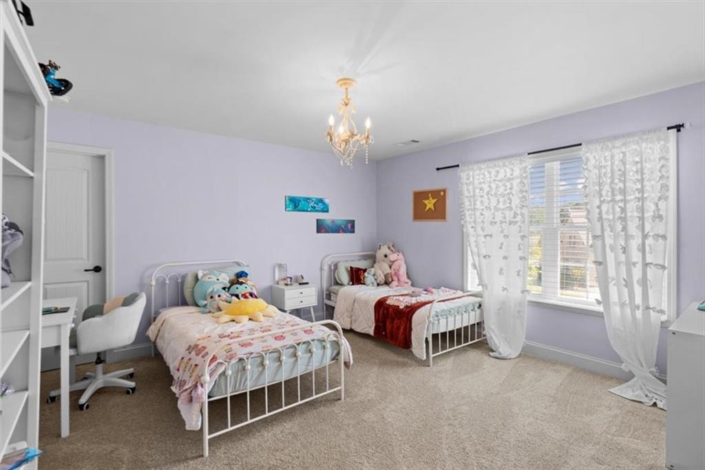 802 Double Branches Lane Dallas, GA 30132 - Photo 32 of 80 a bedroom with two beds window and a chandelier