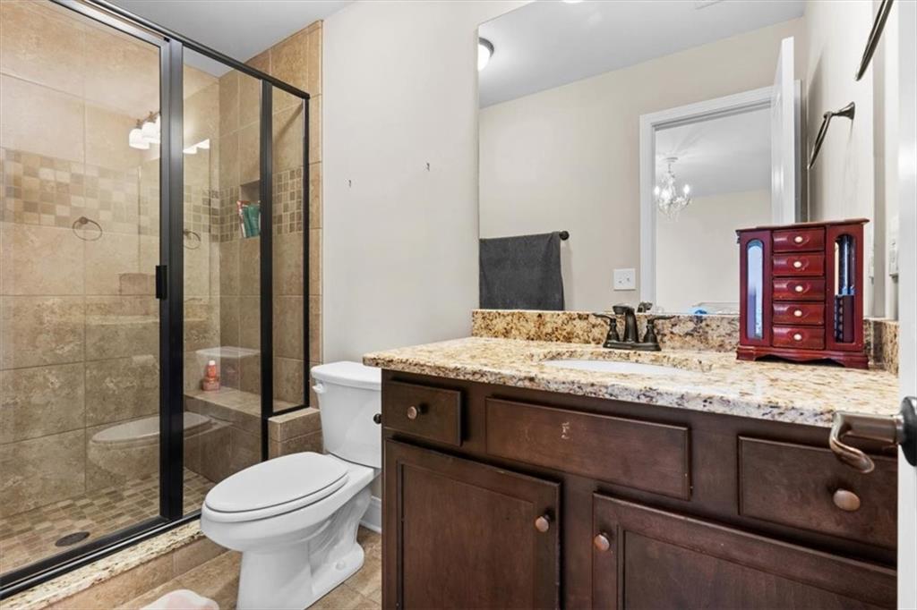 802 Double Branches Lane Dallas, GA 30132 - Photo 33 of 80 a bathroom with a granite countertop sink toilet and shower
