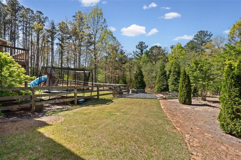 802 Double Branches Lane Dallas, GA 30132 - Photo 67 of 80 a view of a swimming pool with a patio and a garden