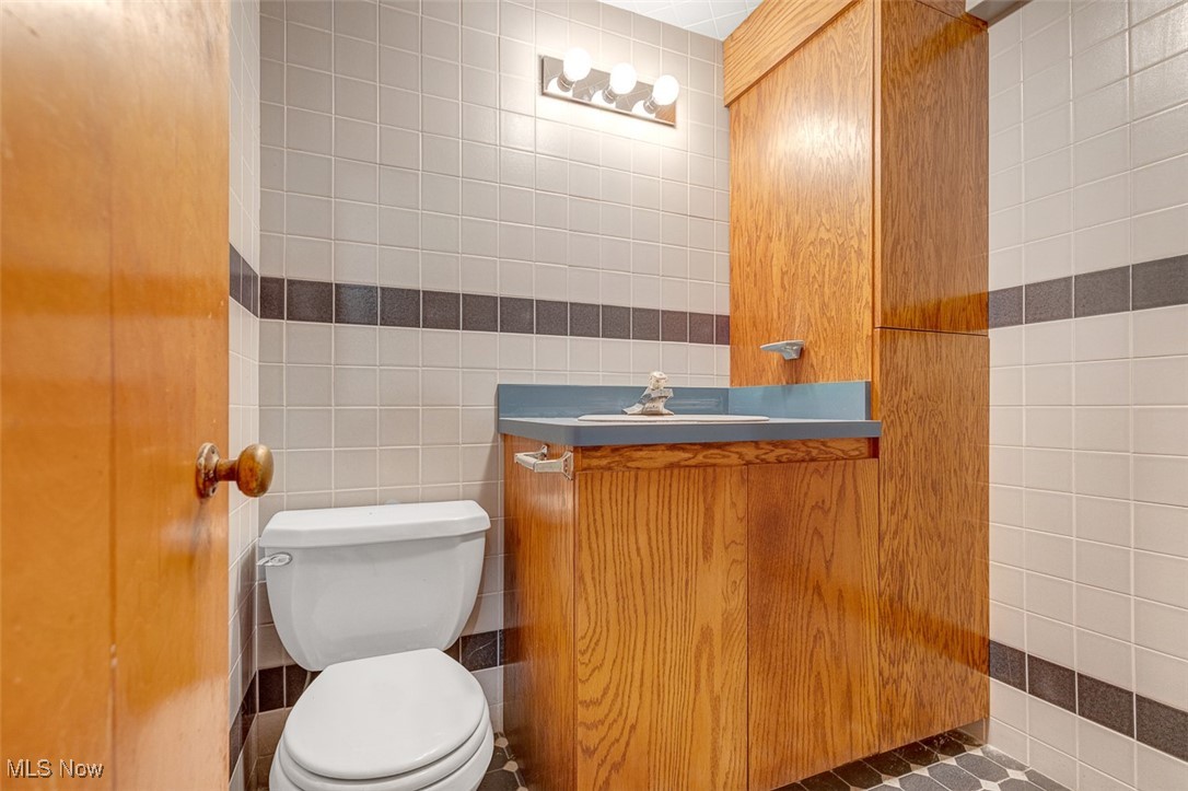 6136 Ridge Road Cleveland, OH 44129 - Photo 33 of 40 Half bath with tile walls and vanity