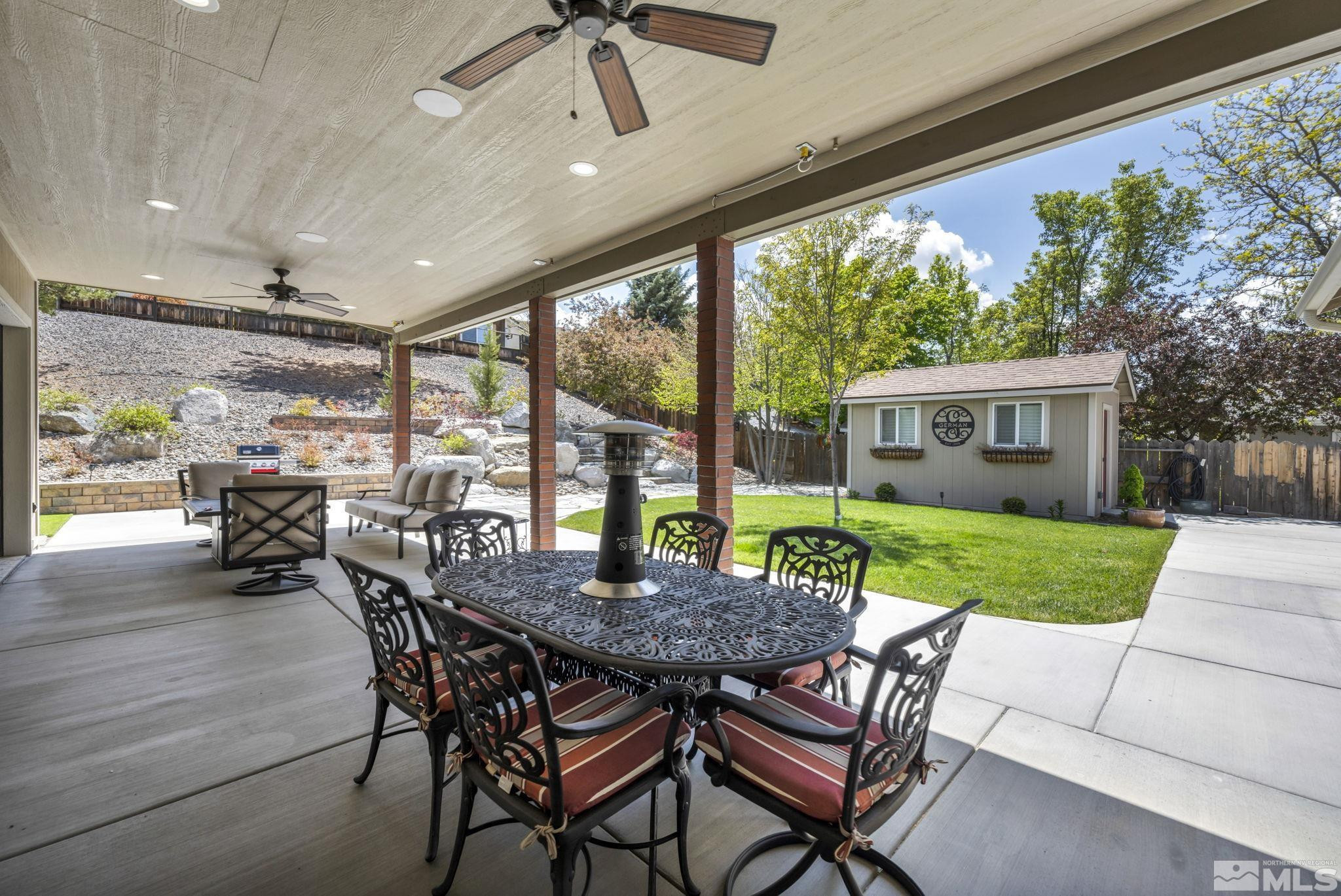 6015 Stillmeadow Drive Reno, NV 89502 - Photo 11 of 39 a view of a patio with a table chairs and a backyard