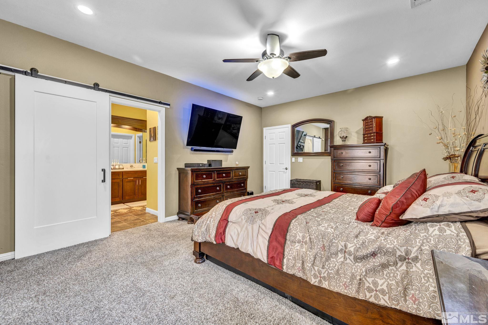 6015 Stillmeadow Drive Reno, NV 89502 - Photo 22 of 39 a bedroom with a bed and a flat screen tv