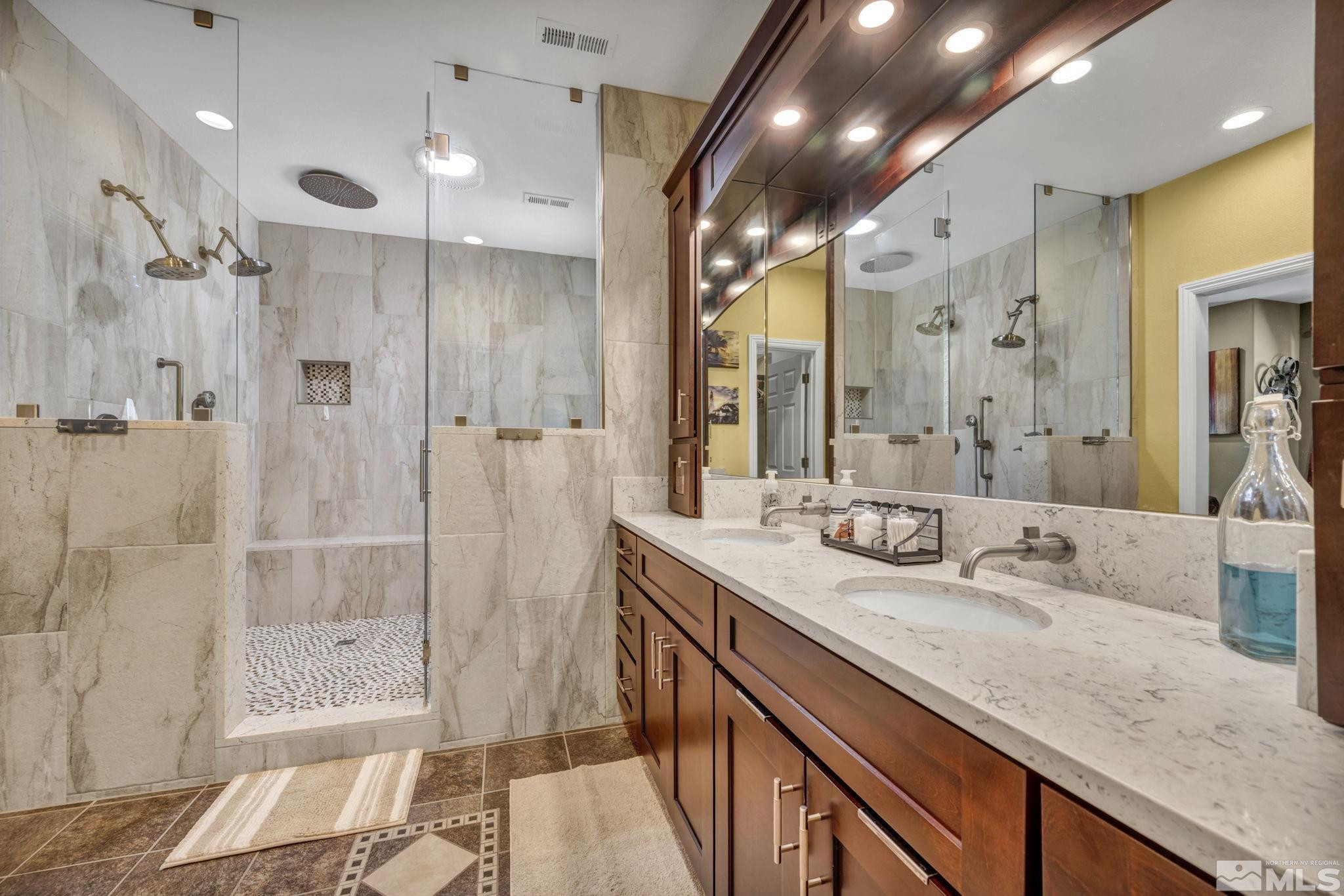 6015 Stillmeadow Drive Reno, NV 89502 - Photo 25 of 39 a bathroom with a granite countertop sink a shower and a mirror