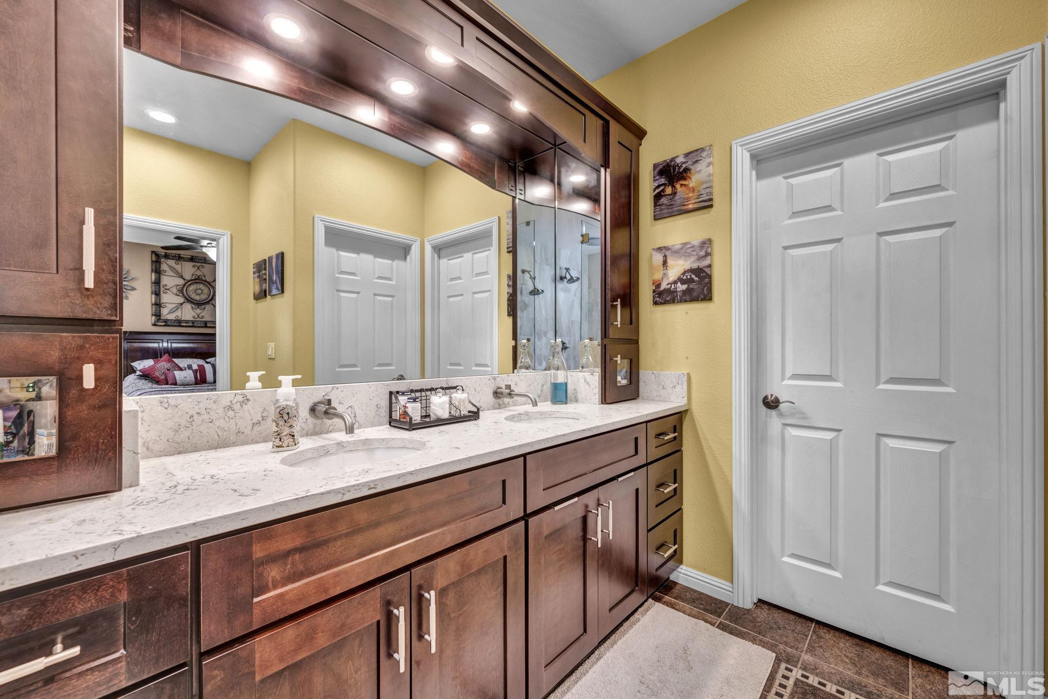 6015 Stillmeadow Drive Reno, NV 89502 - Photo 26 of 39 a bathroom with a double vanity sink and a mirror