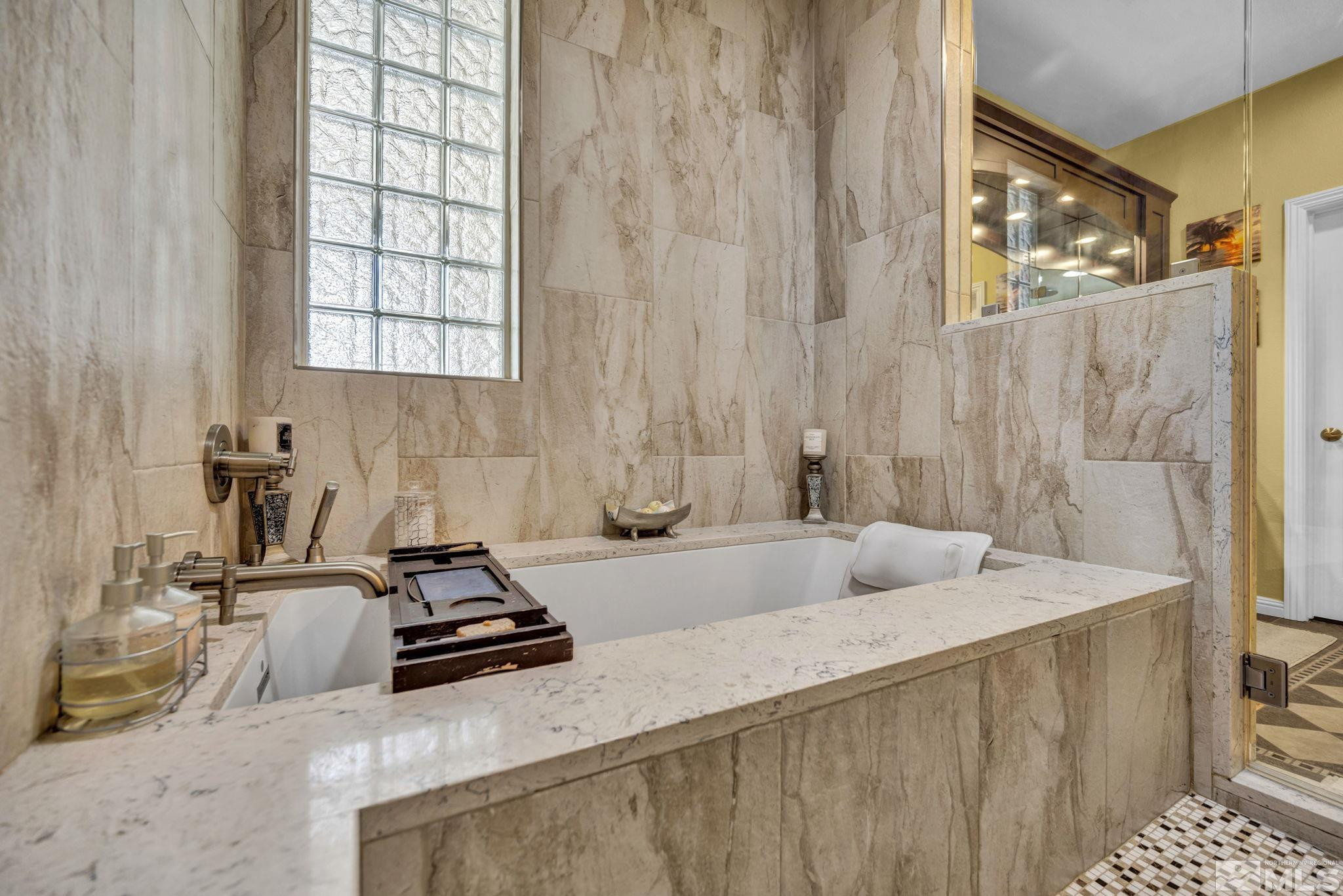 6015 Stillmeadow Drive Reno, NV 89502 - Photo 28 of 39 a bathroom with a granite countertop sink and a mirror